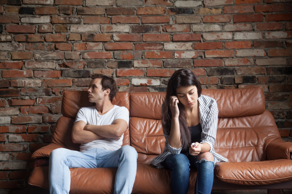 frustrated-upset-couple-after-quarrel-sitting-sofa-home