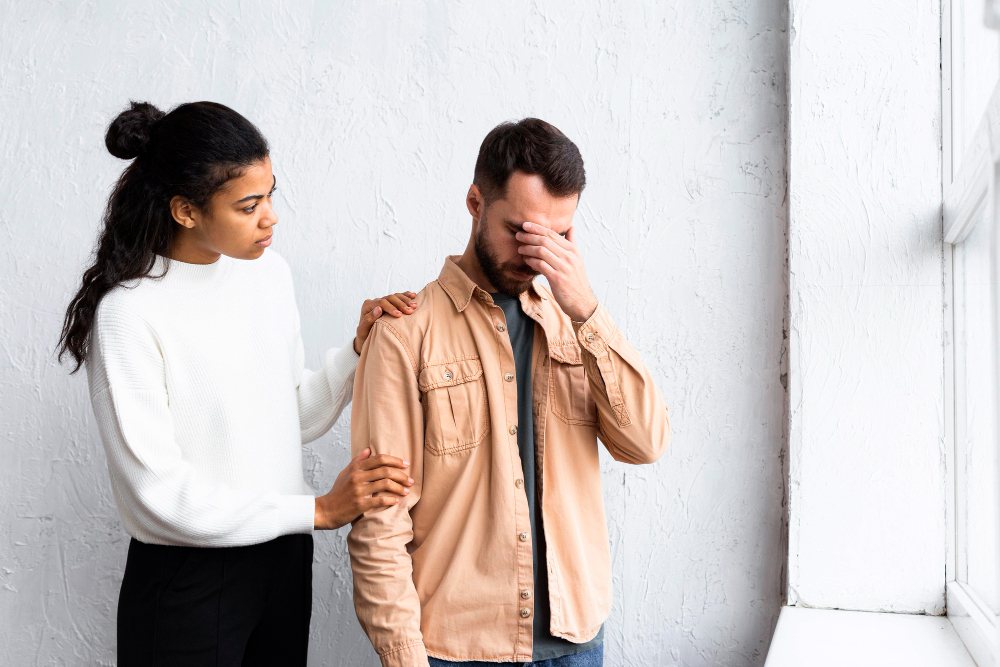 sad-man-being-consoled-by-woman-group-therapy-session